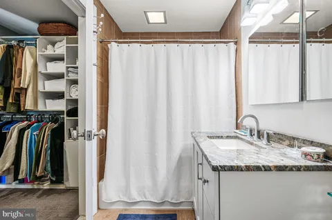 a view of walk in closet with clothes