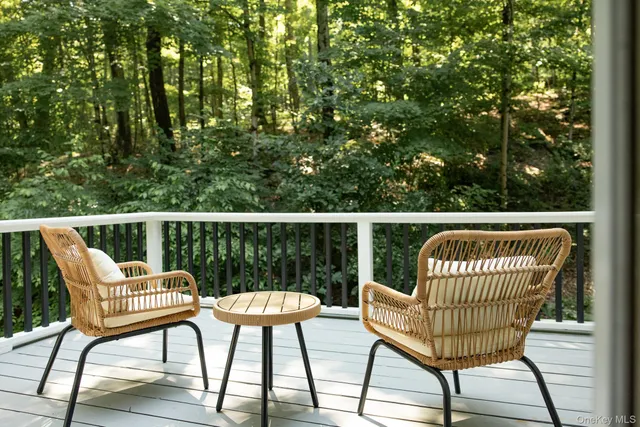 a view of a chair and table on the deck