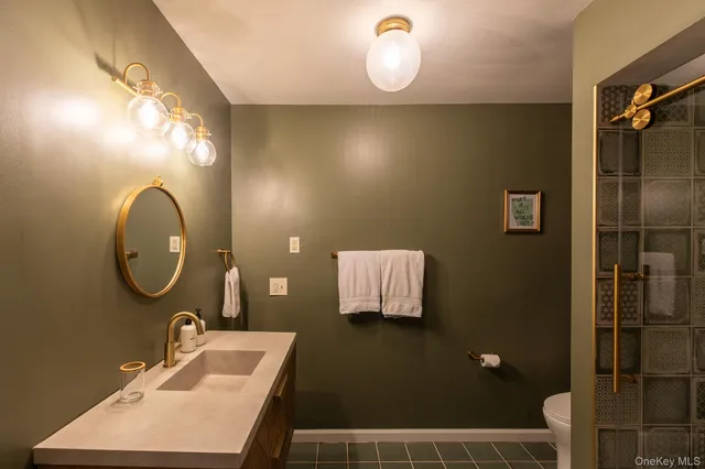 a bathroom with a sink mirror and vanity