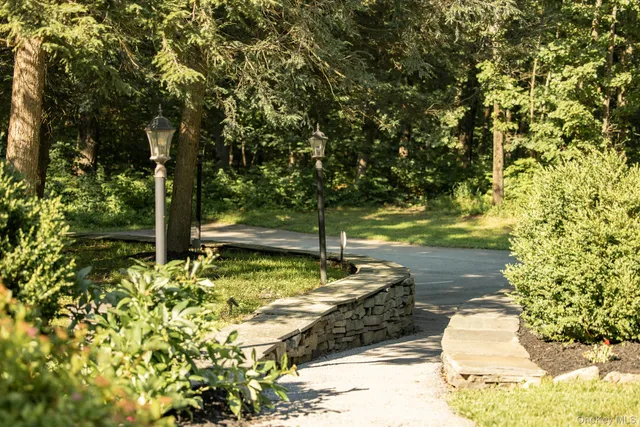 a view of a green field with trees in the background