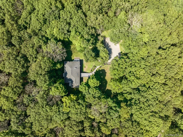 a view of a field of grass and trees