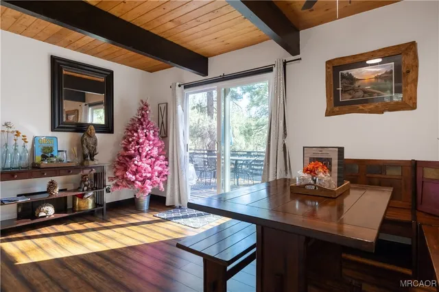 a living room with furniture a flat screen tv and a floor to ceiling window