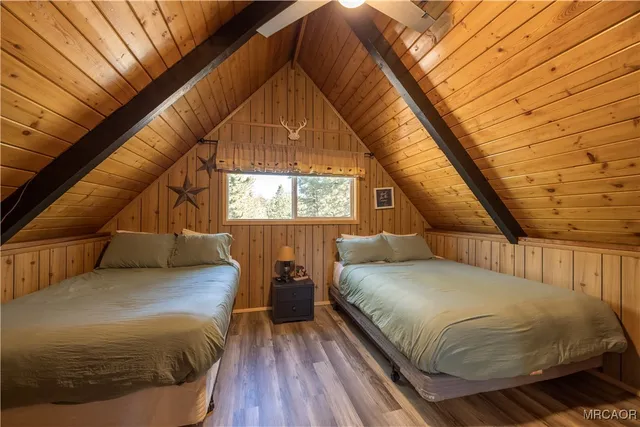 a bed sitting in a bedroom next to a window