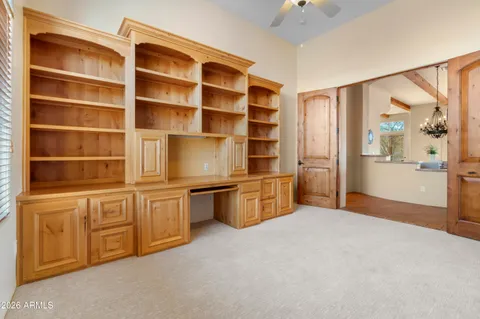 a view of a workspace with furniture and cabinet