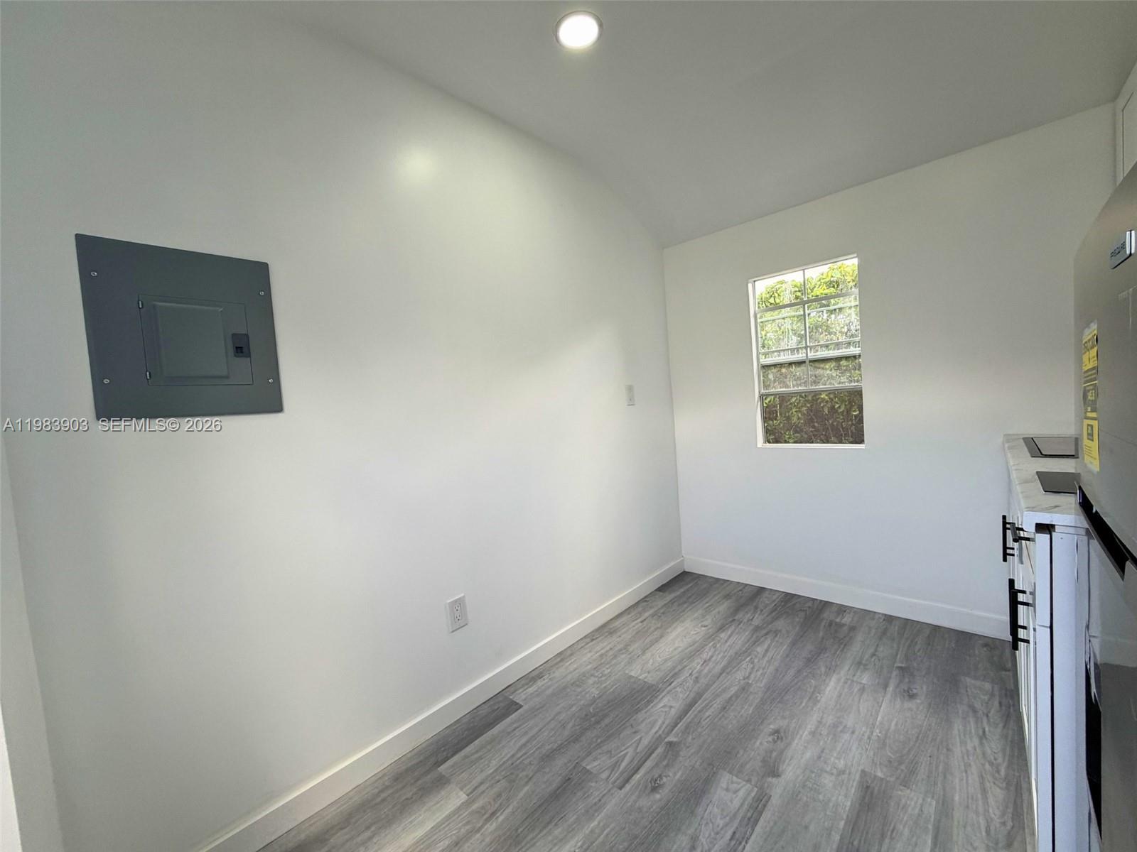 9255 Southwest 43rd Terrace Miami, FL 33165 - Photo 13 of 21 an empty room with a window and wooden floor