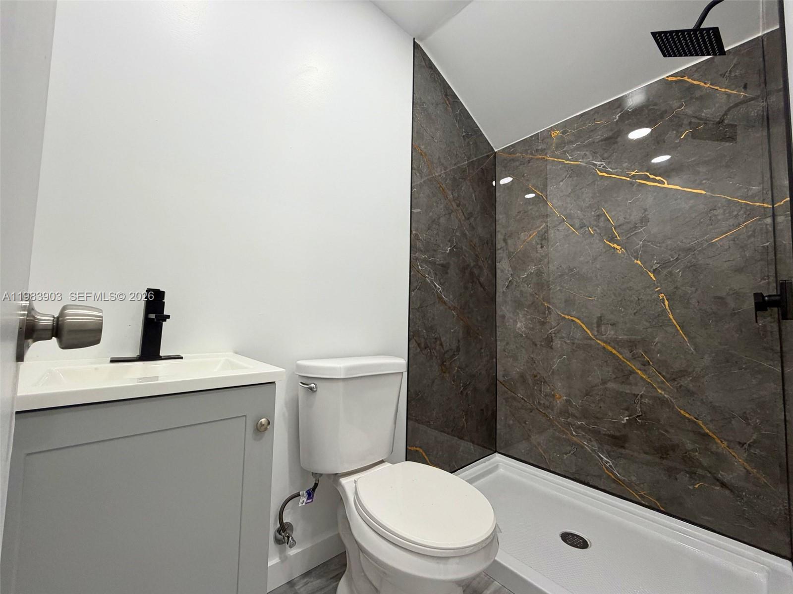 9255 Southwest 43rd Terrace Miami, FL 33165 - Photo 14 of 21 a bathroom with a toilet a sink and shower