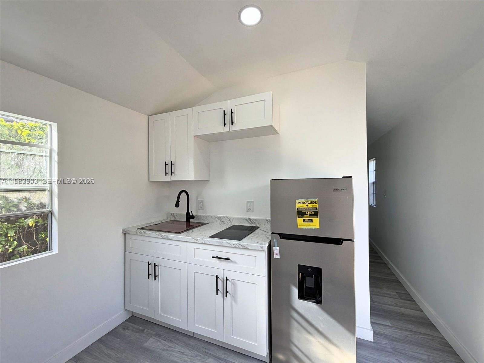 9255 Southwest 43rd Terrace Miami, FL 33165 - Photo 10 of 21 a kitchen with a stove and a cabinets