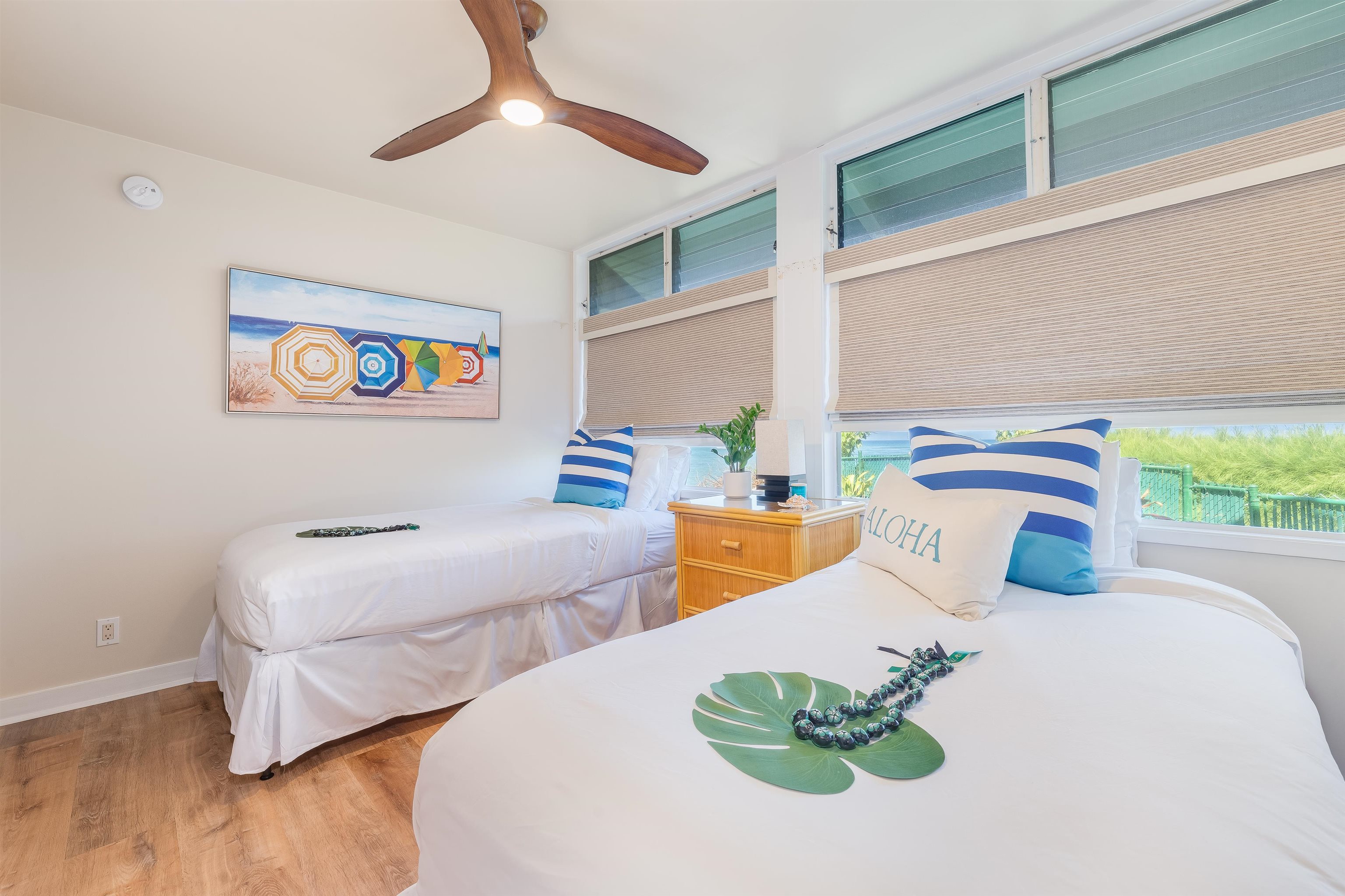 4521 Lower Honoapiilani Road, Unit 3A2 Lahaina, HI 96761 - Photo 20 of 37 a bedroom with 2 bed and a chandelier