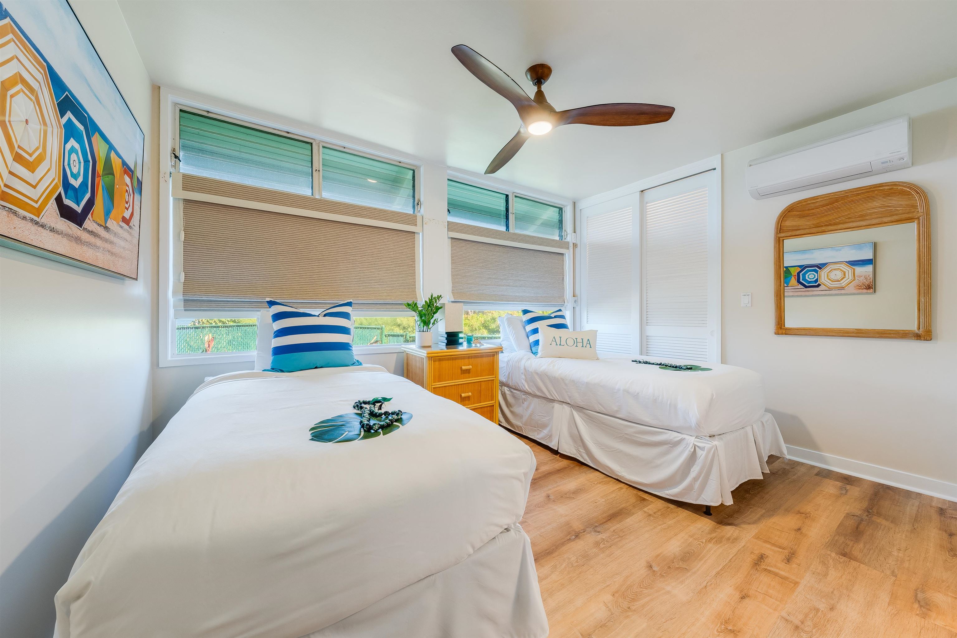 4521 Lower Honoapiilani Road, Unit 3A2 Lahaina, HI 96761 - Photo 21 of 37 a bedroom with a bed and a painting on the wall