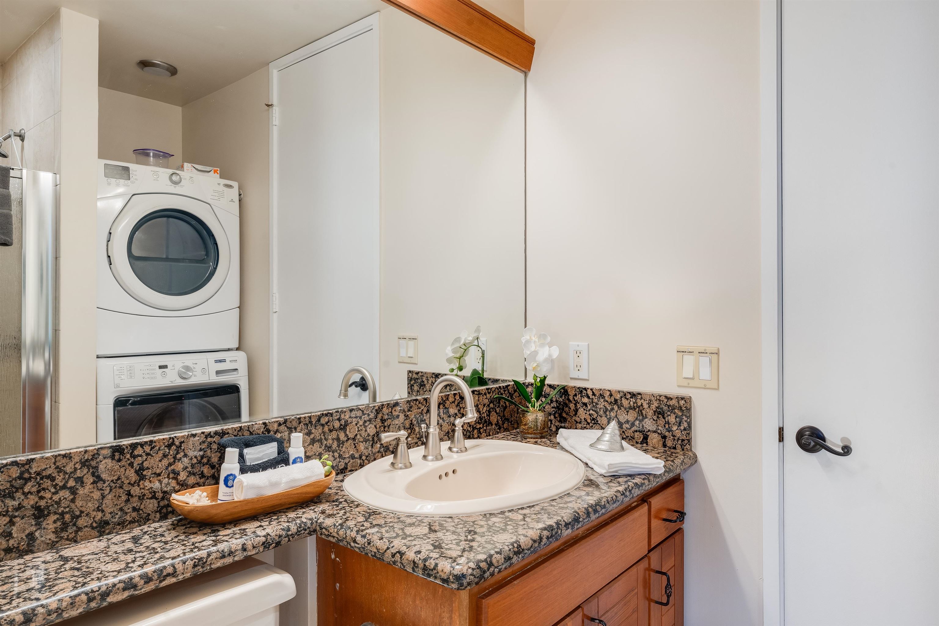 4521 Lower Honoapiilani Road, Unit 3A2 Lahaina, HI 96761 - Photo 22 of 37 a bathroom with a granite countertop sink and a mirror