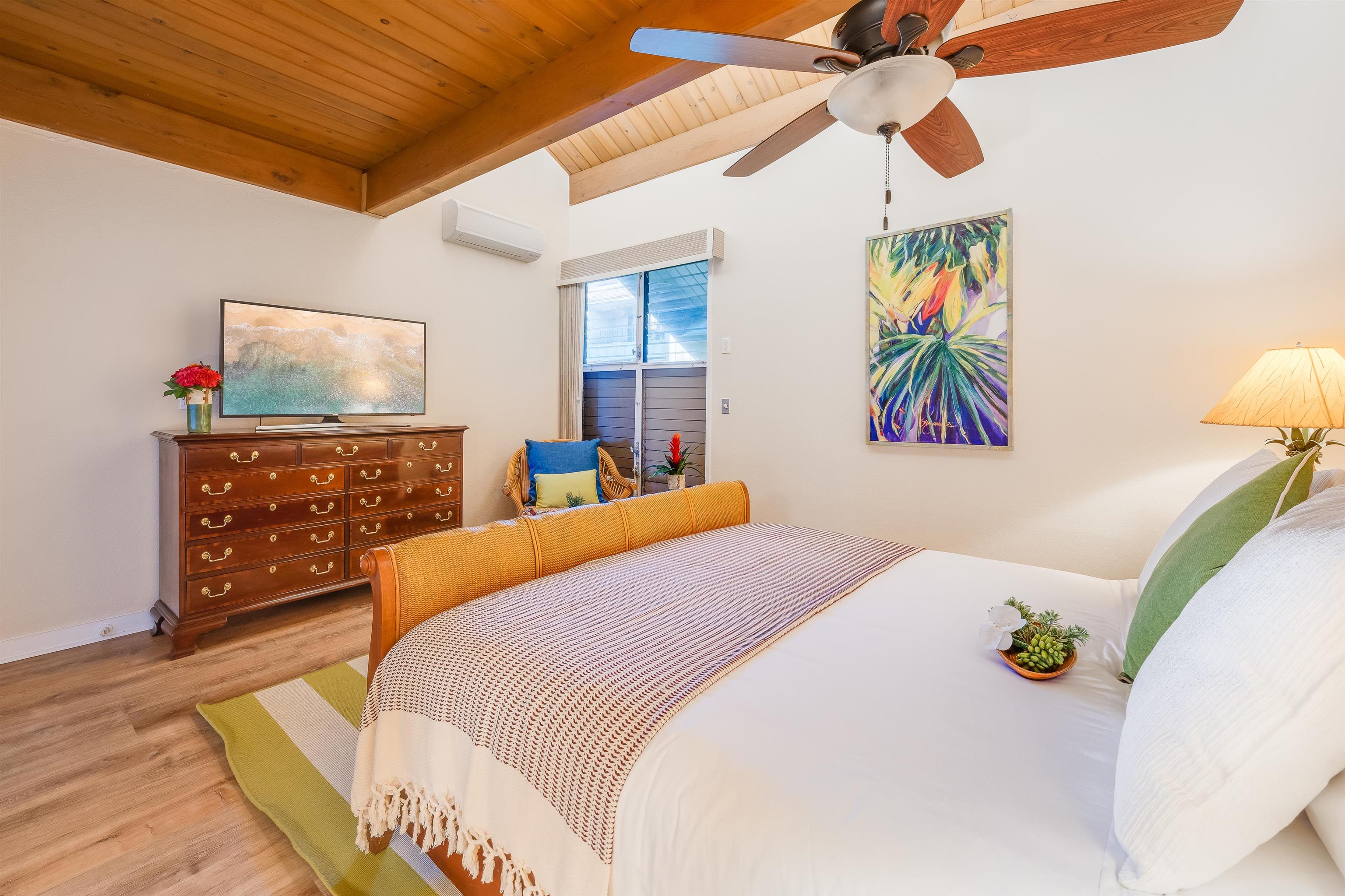 4521 Lower Honoapiilani Road, Unit 3A2 Lahaina, HI 96761 - Photo 25 of 37 a bedroom with a bed and a chandelier