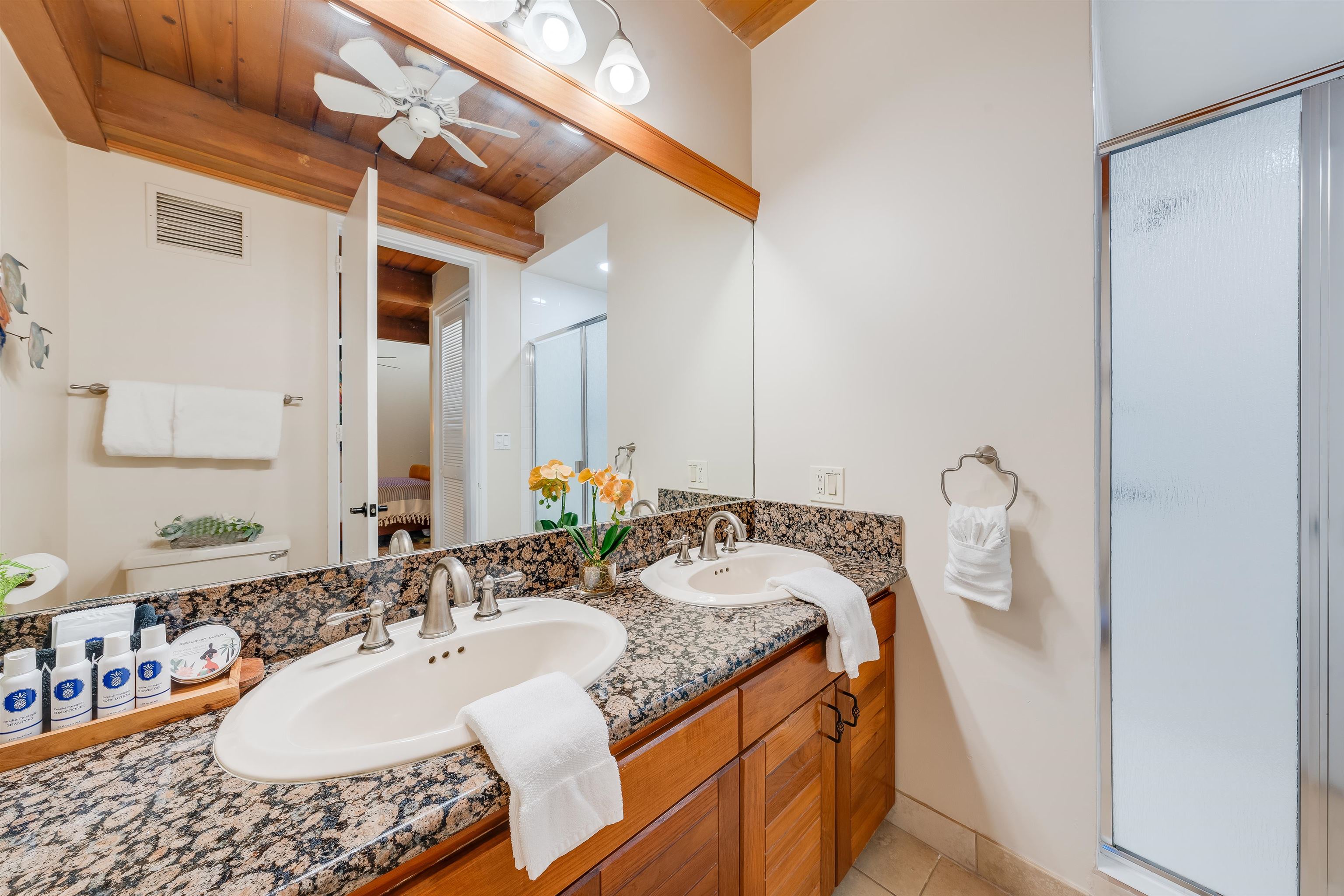 4521 Lower Honoapiilani Road, Unit 3A2 Lahaina, HI 96761 - Photo 29 of 37 a bath room with a granite countertop sink and a mirror