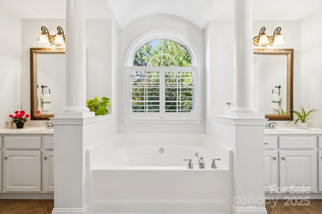 a bathroom with a bathtub a sink and a window