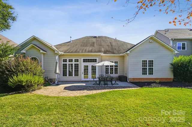 a front view of a house with yard and green space