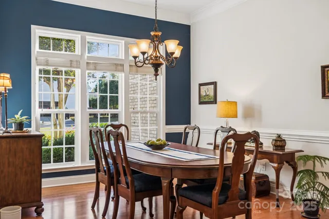 a view of a dining room with furniture and chandelier