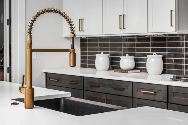 a bathroom with a granite countertop sink mirror and bathtub