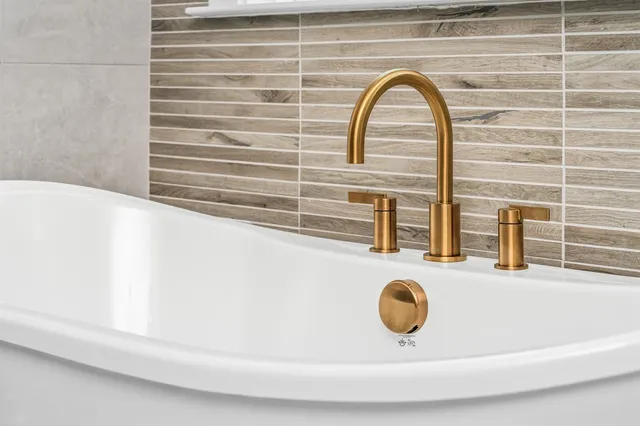 a bathroom with a sink a toilet a mirror a vanity and shower