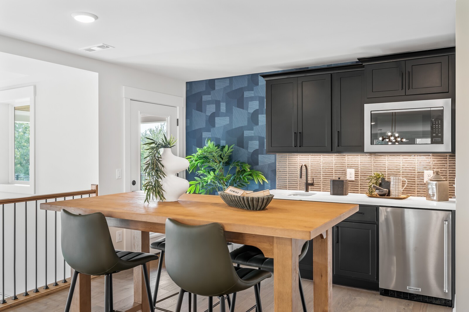 7221 Severide Street Fairview, TN 37062 - Photo 65 of 96 a kitchen with a table chairs refrigerator and cabinets