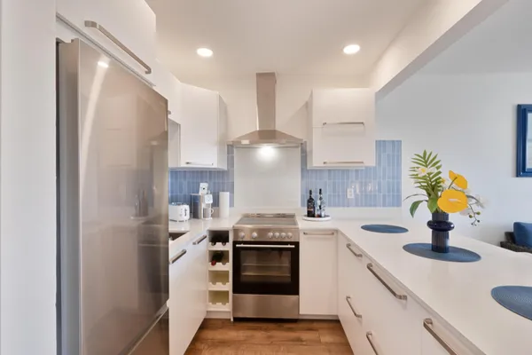 a kitchen with a sink stove and refrigerator