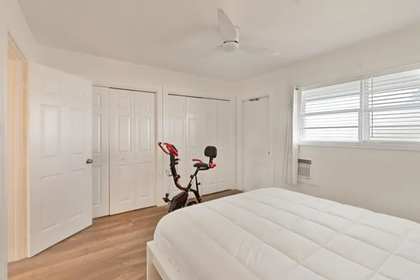 a bedroom with a bed and a chair