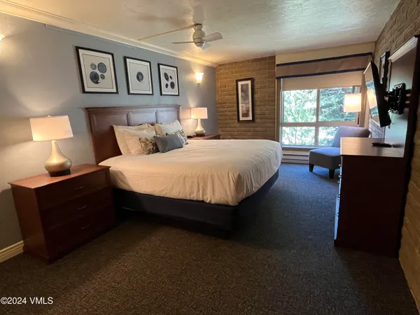 a bed room with a bed and a night stand