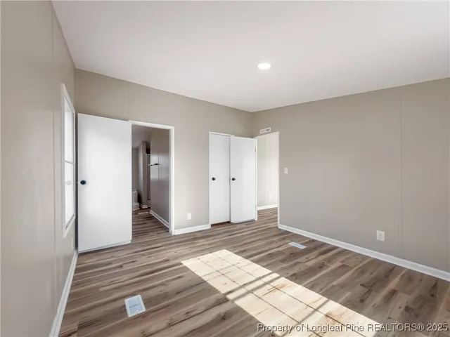 a view of an empty room and wooden floor