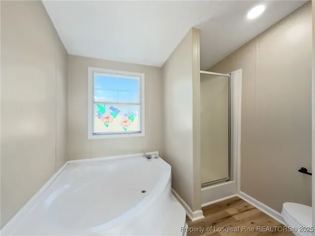 a bathroom with a tub and a window