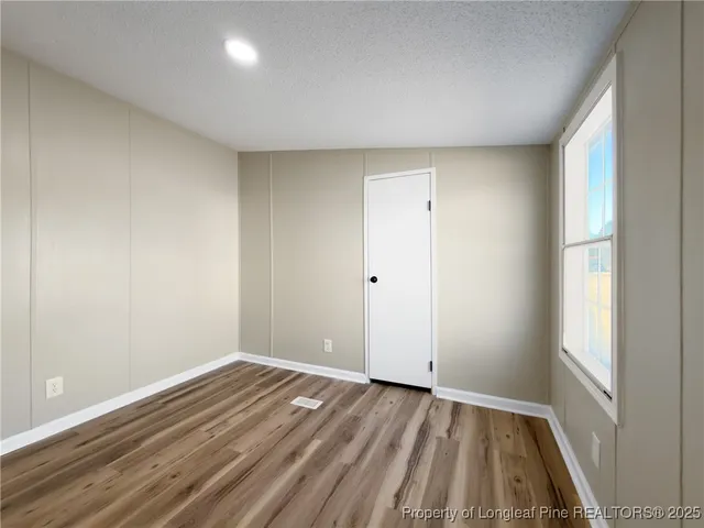 a view of room with window and hardwood floor