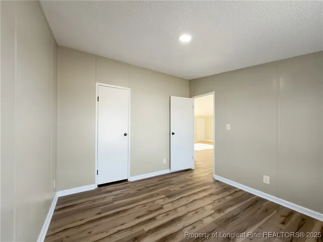 a view of an empty room and wooden floor