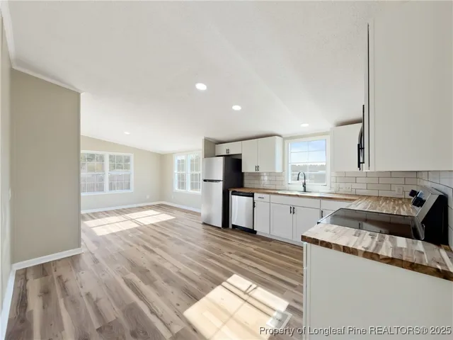 a kitchen that has a sink and cabinets in it