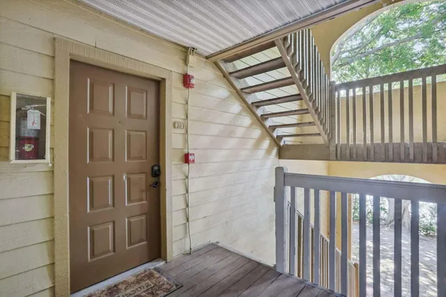 a view of a wooden door and a window