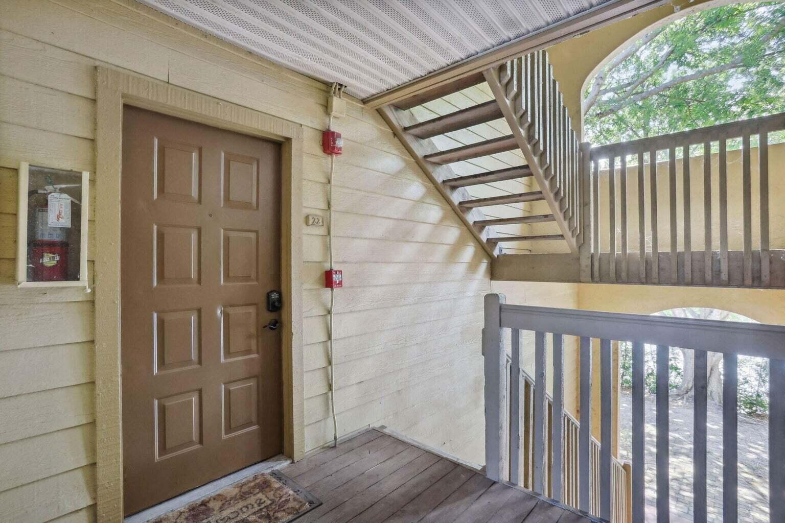 a view of a wooden door and a window