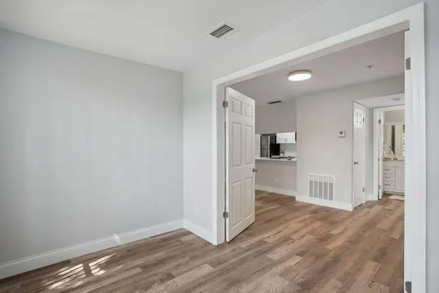 a view of a kitchen with wooden floor and a sink