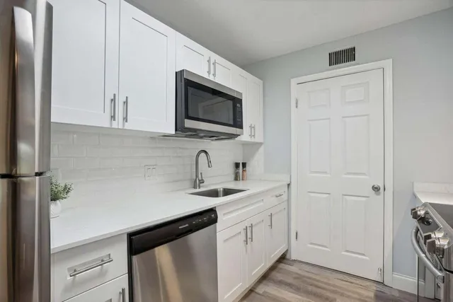 a kitchen with a sink and a stove top oven