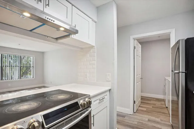 a kitchen with a stove and a window