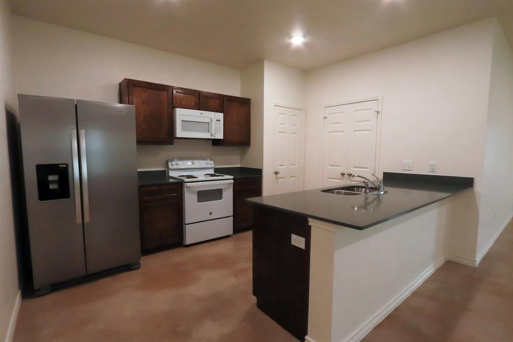2316 Alterman Drive, Unit A Temple, TX 76504 - Photo 1 of 3 a kitchen with stainless steel appliances granite countertop a sink stove and refrigerator