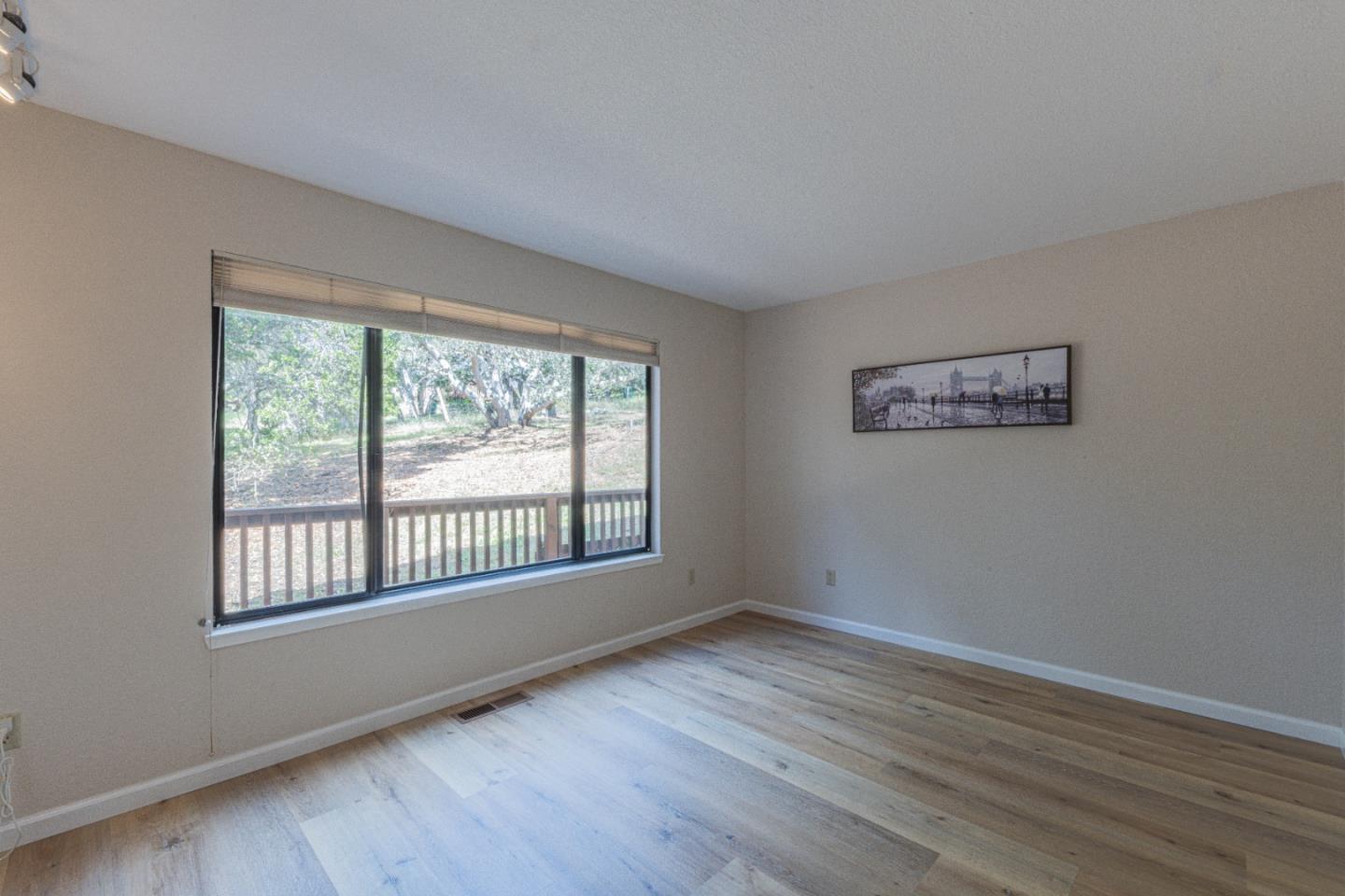 6959 Valle Pacifico Road Salinas, CA 93907 - Photo 25 of 45 a view of an empty room with wooden floor and a window