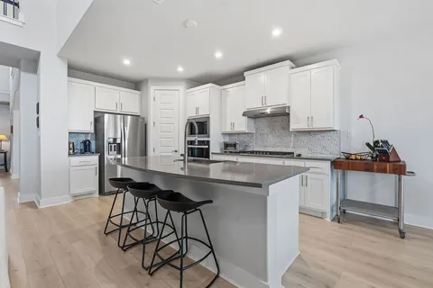 a kitchen with counter top space and stainless steel appliances