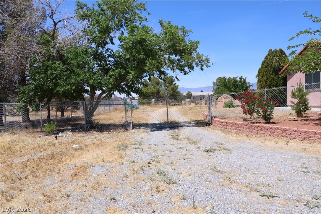 1220 East Gamebird Road Pahrump, NV 89048 - Photo 3 of 49 RV Parking on the side of the lot for enough space for all your toys. .
