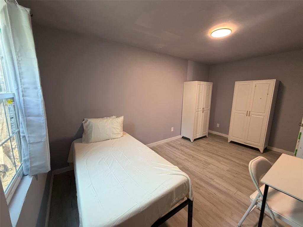 513 Shawnee Trace Grand Prairie, TX 75051 - Photo 11 of 32 Room featuring light gray walls and wood-finish flooring
