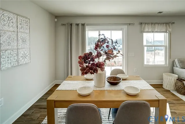 a view of a dining room with furniture and window