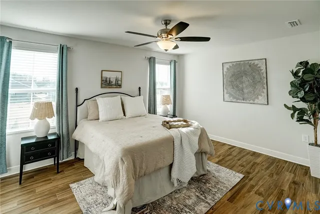 a bedroom with a bed and wooden floor