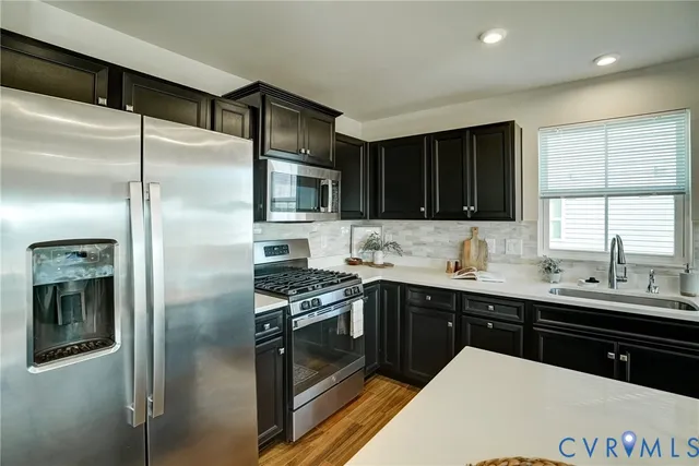 a kitchen with a sink stainless steel appliances and cabinets