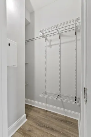 a view of a room with wooden floor and white walls