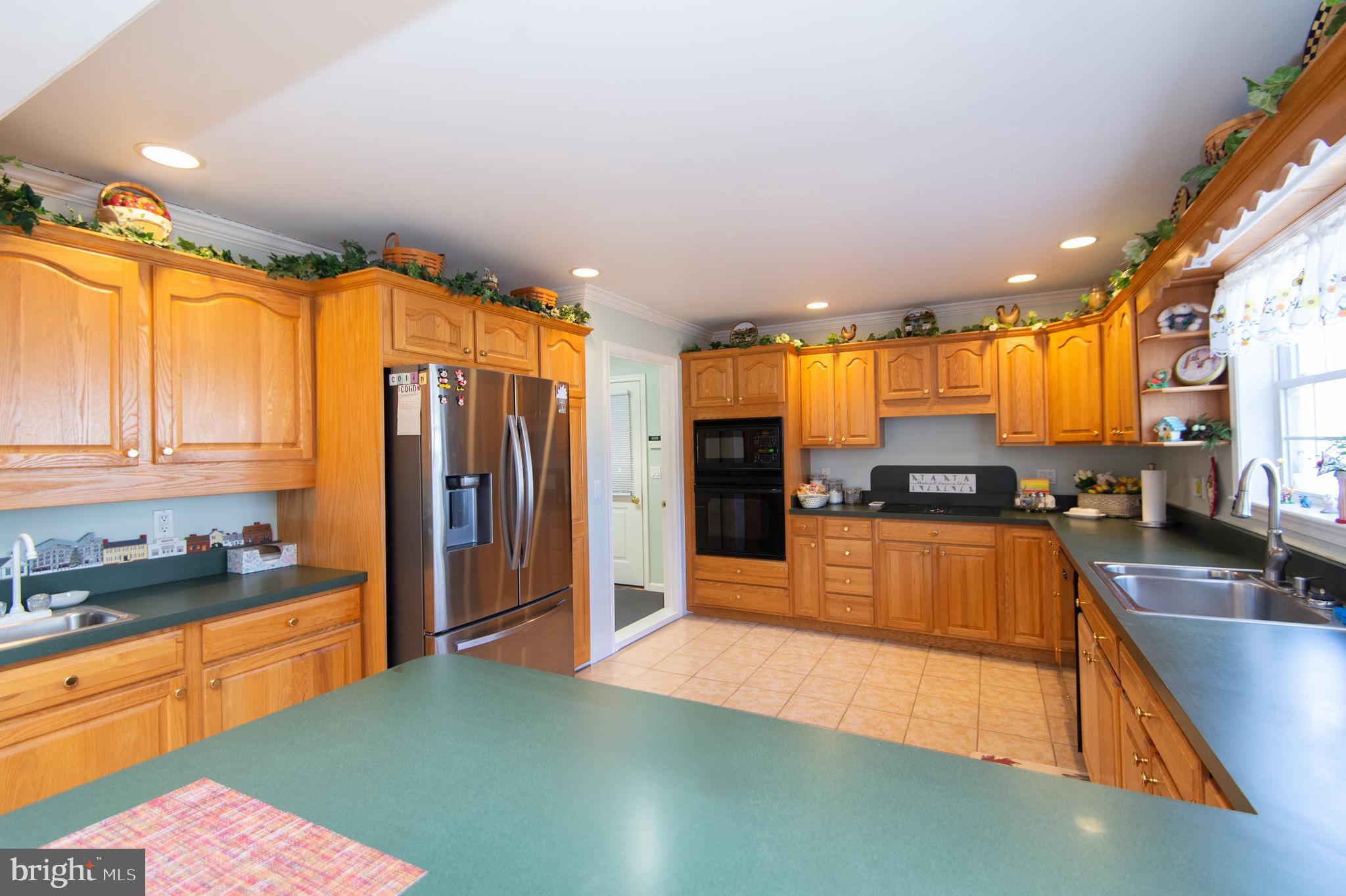 9 Holly Terrace Cambridge, MD 21613 - Photo 15 of 49 a large kitchen with stainless steel appliances a large counter top a stove a refrigerator a sink and dishwasher