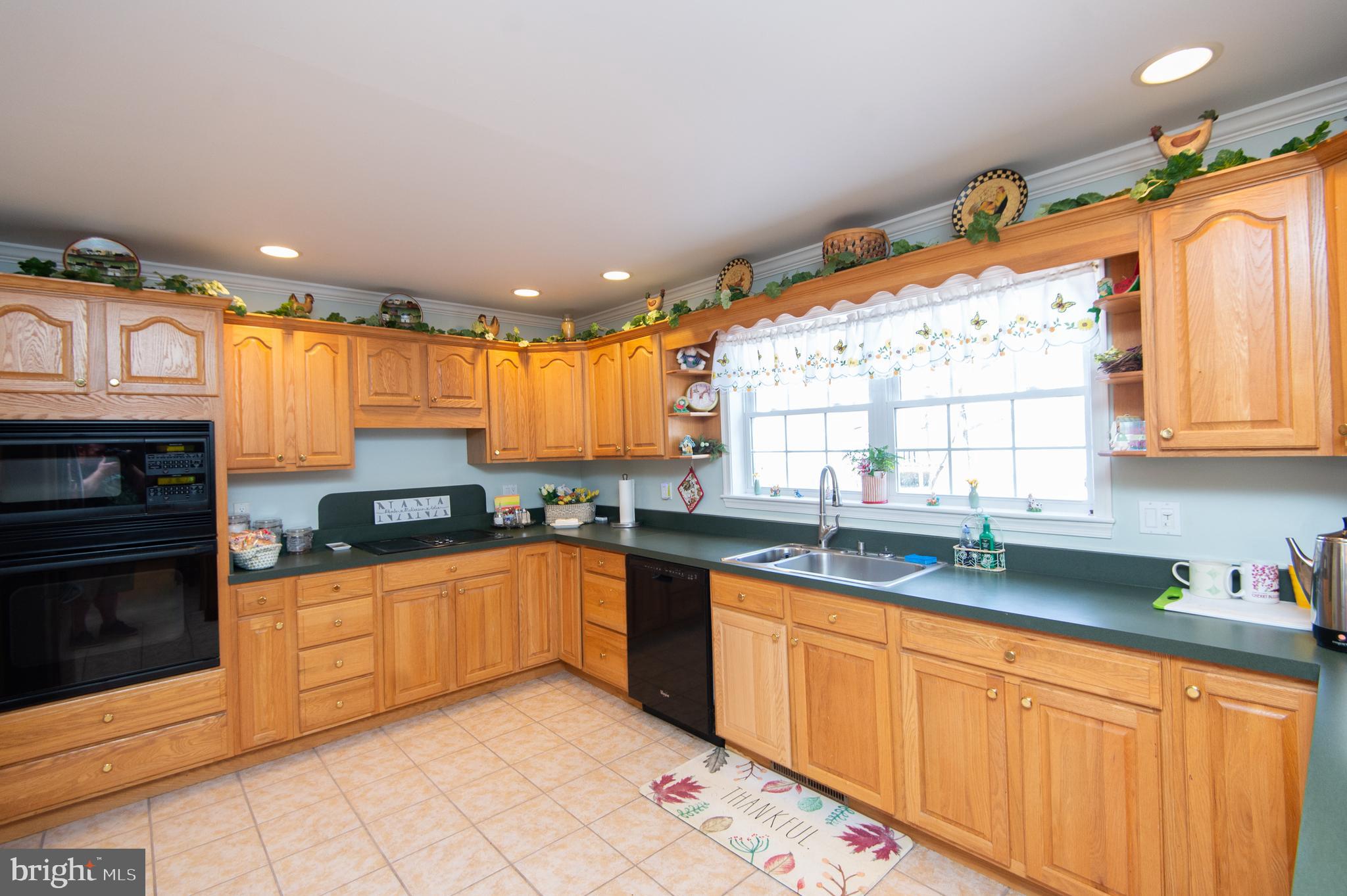 9 Holly Terrace Cambridge, MD 21613 - Photo 16 of 49 a large kitchen with stainless steel appliances granite countertop a sink and cabinets
