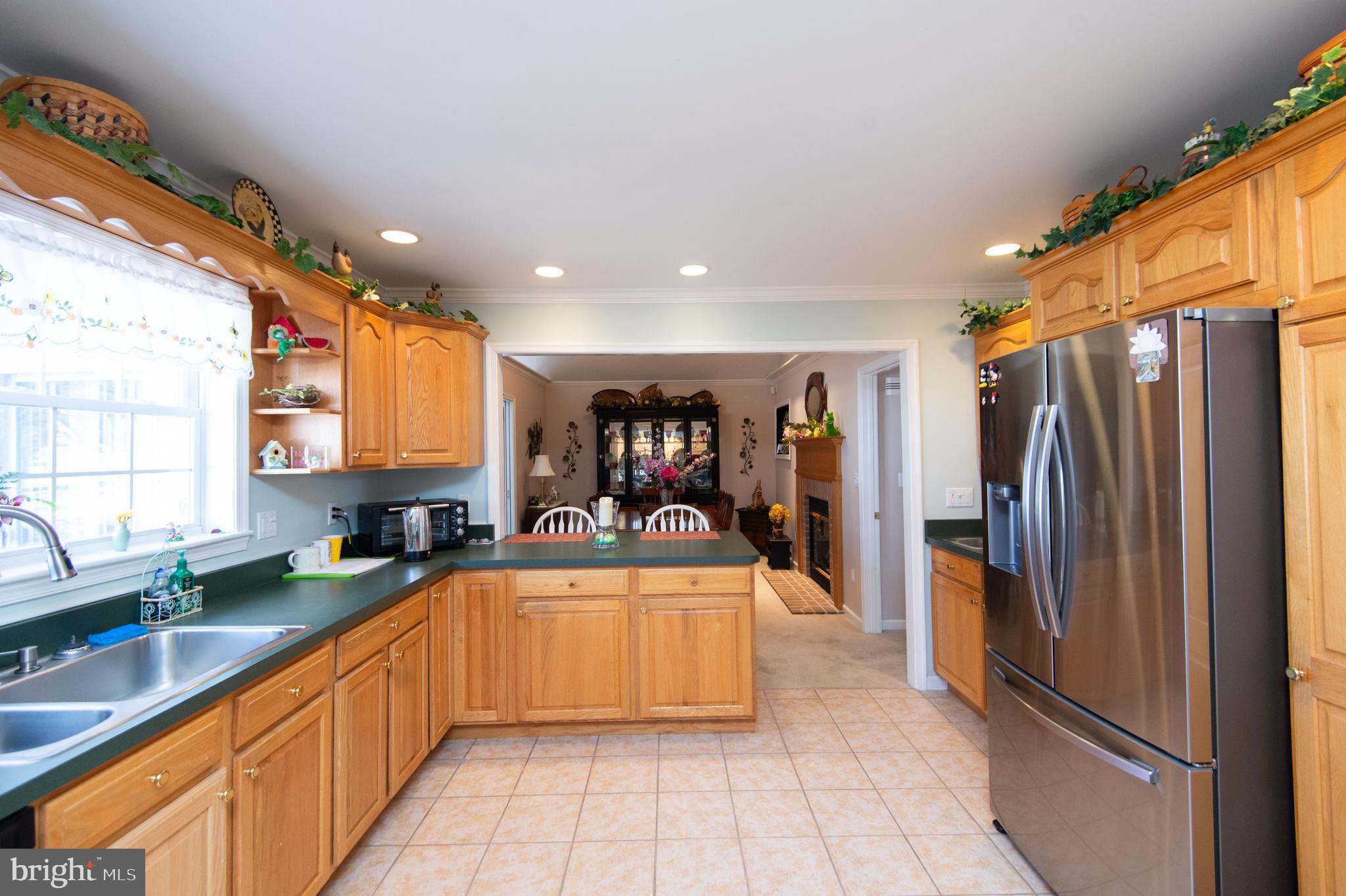9 Holly Terrace Cambridge, MD 21613 - Photo 19 of 49 a large white kitchen with a large window and refrigerator