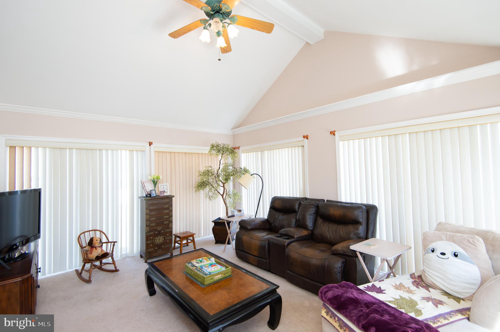 9 Holly Terrace Cambridge, MD 21613 - Photo 24 of 49 a living room with furniture a flat screen tv and a window