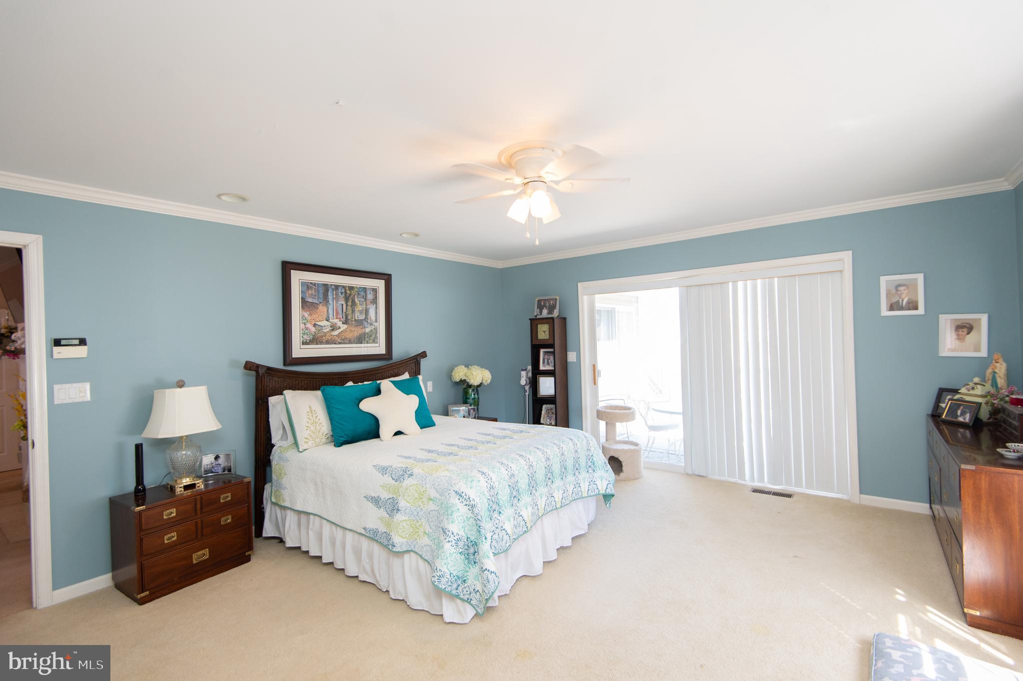 9 Holly Terrace Cambridge, MD 21613 - Photo 29 of 49 a bedroom with a bed and a chandelier