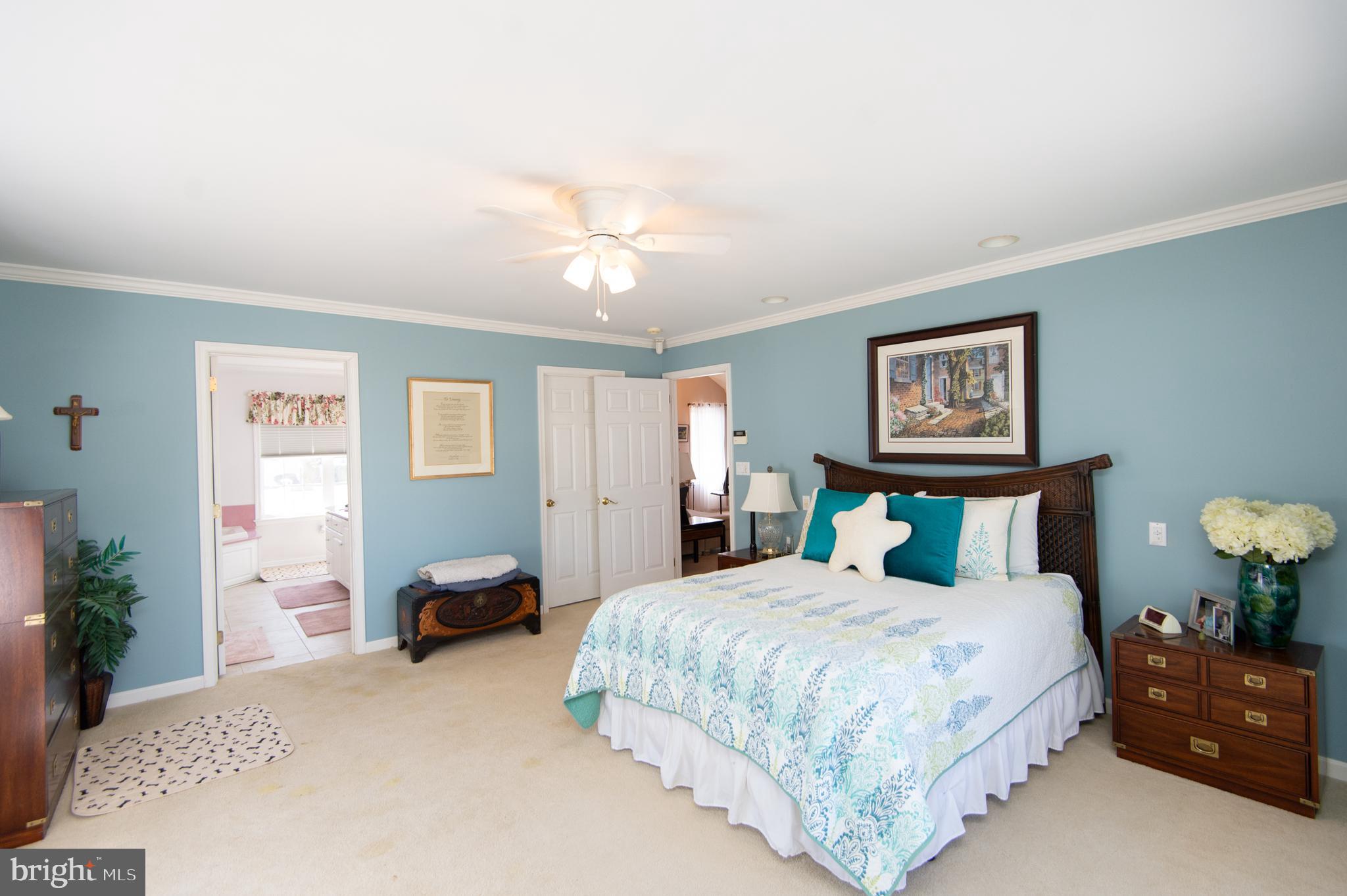 9 Holly Terrace Cambridge, MD 21613 - Photo 30 of 49 a bedroom with a bed and a chandelier